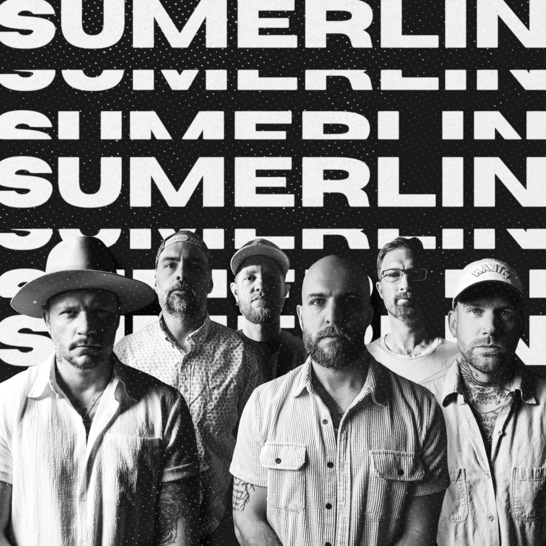 Sumerlin performing live in red stage lighting